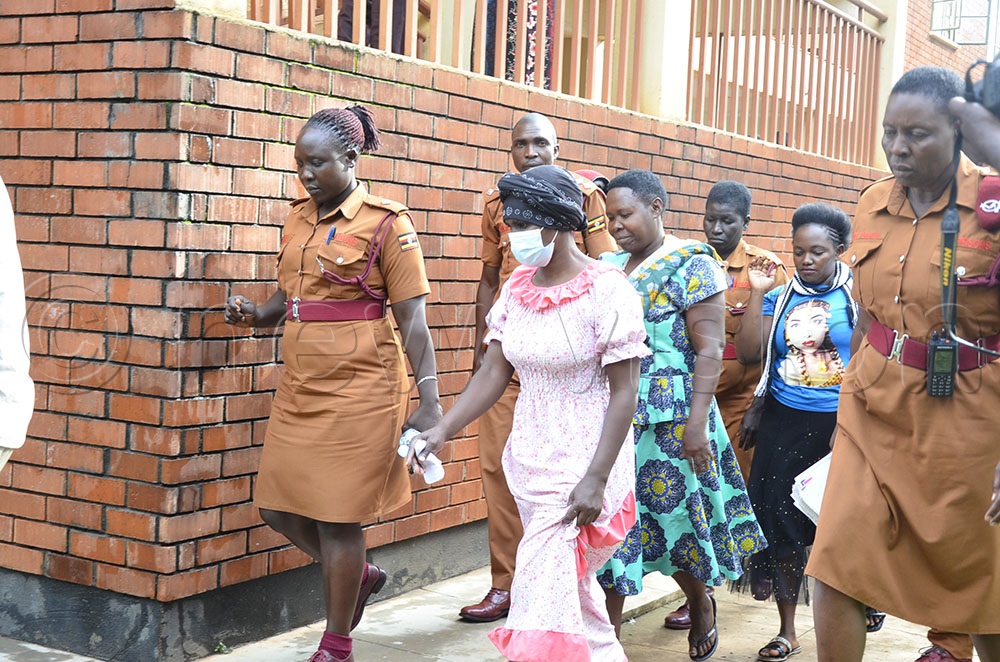  Betty Cherotich (in front) being escorted to the waiting cell after appearing in court. (Photo by Yosam Gucwaki)