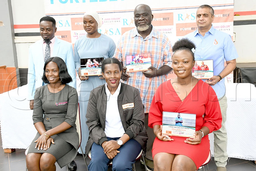 L-R: Seated: Jude Colour Solutions' Judith Juliet Nabuule, Fortebet's Assistant Media Manager Resty Mbatidde Namugema and Angel Ainemani pose with Real Stars Awards' Isac Mukasa, Aminah Kakande, Ali Kavuma and Yasin Nasser, October 7, 2025. Photo by Michael Nsubuga