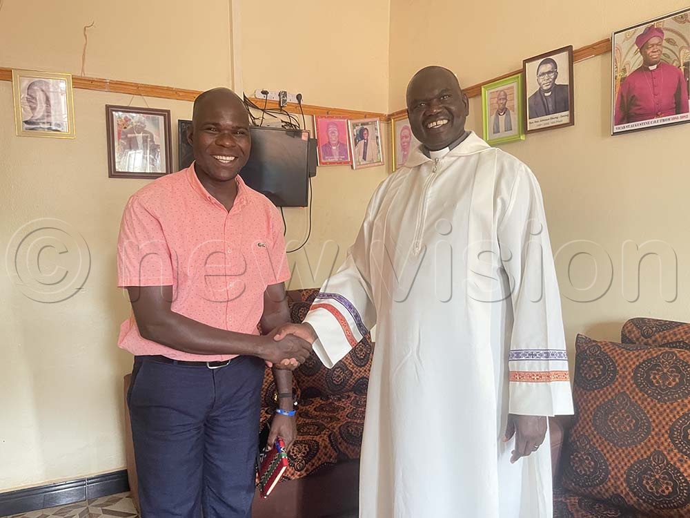 Radio Rupiny Station Manager, Peter Labeja (L), greets the Vicar of Saint Augustine Church, Rev. Canon Moses Peter Ocwero, in his office. (Credit: Jackson Kitara)