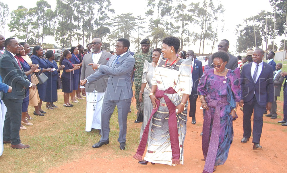 Katikkiro Charles Peter Mayiga shares a light moment with the staff members of TRICONA. (Photo by Mathias Mazinga)