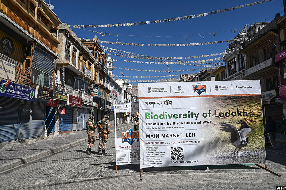 Indo-Tibetan Border Police (ITBP) personnel patrol along a street during a curfew in Leh on September 27, 2025