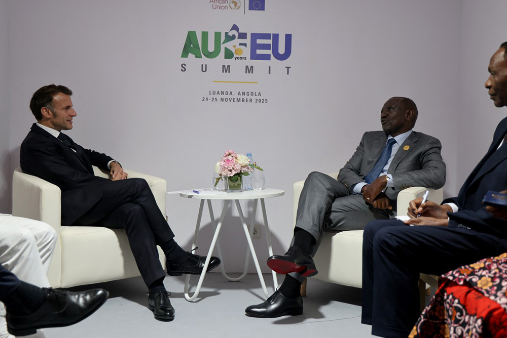France's President Emmanuel Macron (L) sits during a bilateral meeting with Kenya's President William Ruto (R) during the Africa Union (AU) - European Union (EU) Summit the Salao Protocolar in Luanda on November 24, 2025. (Photo by Ludovic MARIN / AFP)
