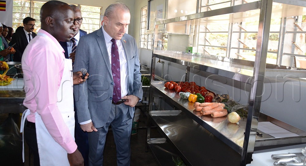 Mehmet inspecting the modern kitchen at IUIU which is containing the kitchen equipment donated by TiKA.