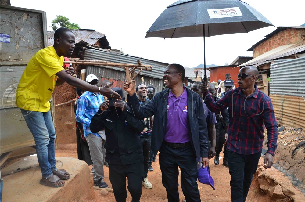 Michael Bayinda, a self-confessed NRM supporter engaging with ANT presidential candidate, rtd. Gen. Mugisha Muntu in Kisenyi.