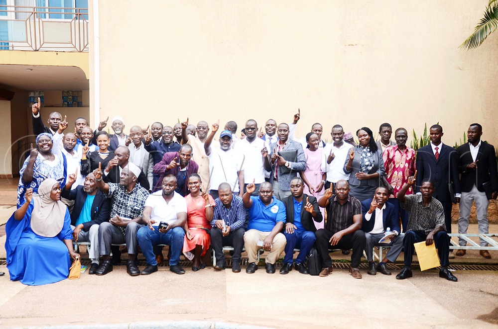 The Justice Forum (JEEMA) party president, Asuman Basalirwa and other party members in a group picture after the NEC meeting at Tal Cottages in Rubaga division. (Photo by Isaac Nuwagaba)
