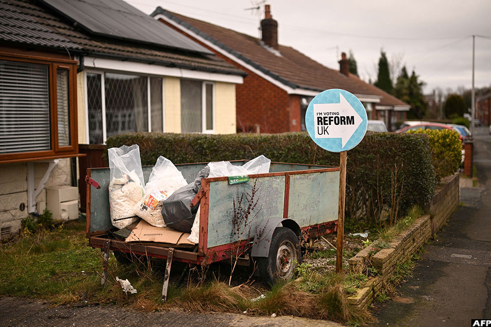 A poster supporting Britain's Reform UK party is pictured outside of a residential property in Denton, Greater Manchester on February 12, 2026, as parties began to canvas voters ahead of the crucial Gorton and Denton by-election. (AFP)