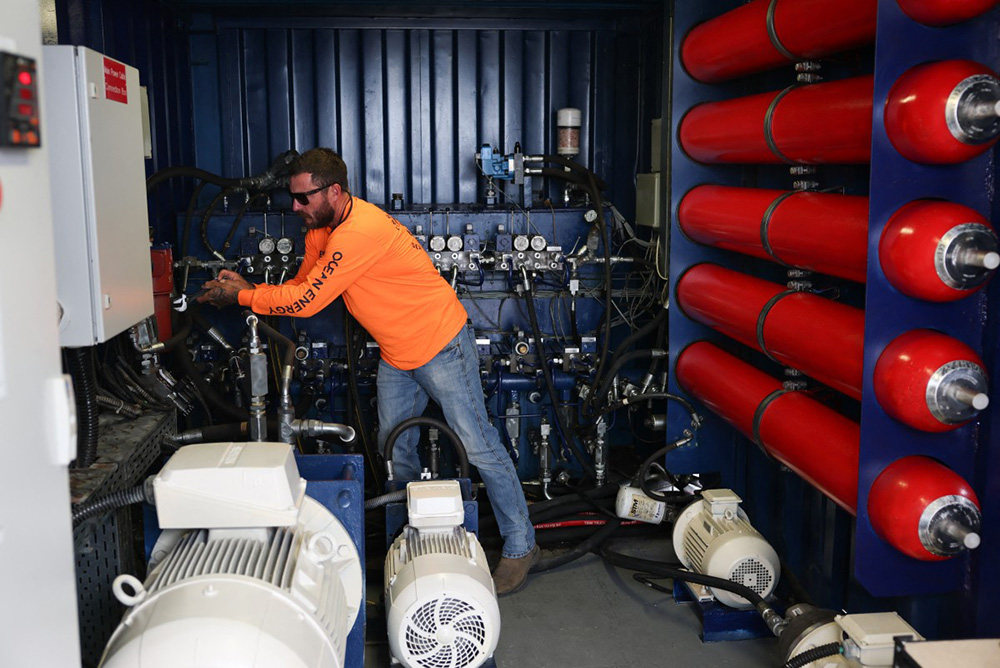 Ian Crichton, owner of C&S Welding, checks a component during a demonstration of Eco Wave Power electricity generation technology using the power of ocean waves in the harbor at AltaSea at the Port of Los Angeles in San Pedro, California, on August 26, 2025. (Photo by Patrick T. Fallon / AFP)