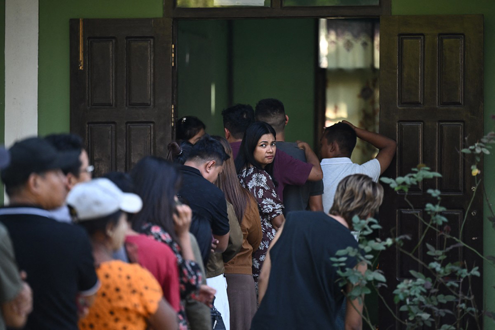 Voters wait in line at a polling station during the first phase of Myanmar's general election in Naypyidaw on December 28, 2025. (Photo by Sai Aung MAIN / AFP)