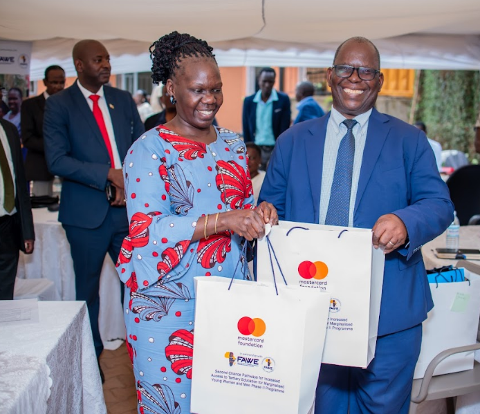 Opok, Executive Director FAWE Uganda, gifts Tagwira, head of delegation from Zimbabwe. (Courtesy)