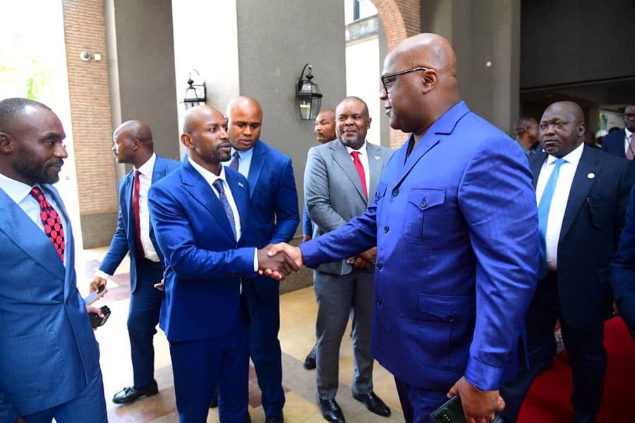 Williams Bugeme shakes hands with the Congolese President Felix Tshisekedi