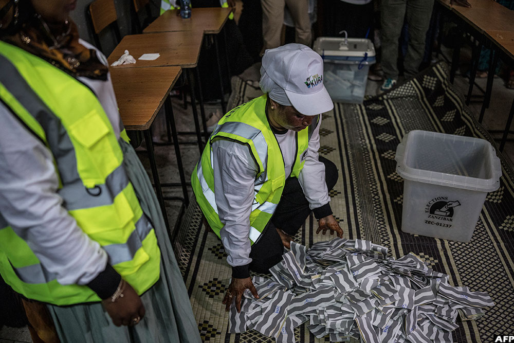 Polling station officials spread the ballots at the beginning of the counting operations in Stone Town, on October 29, 2025