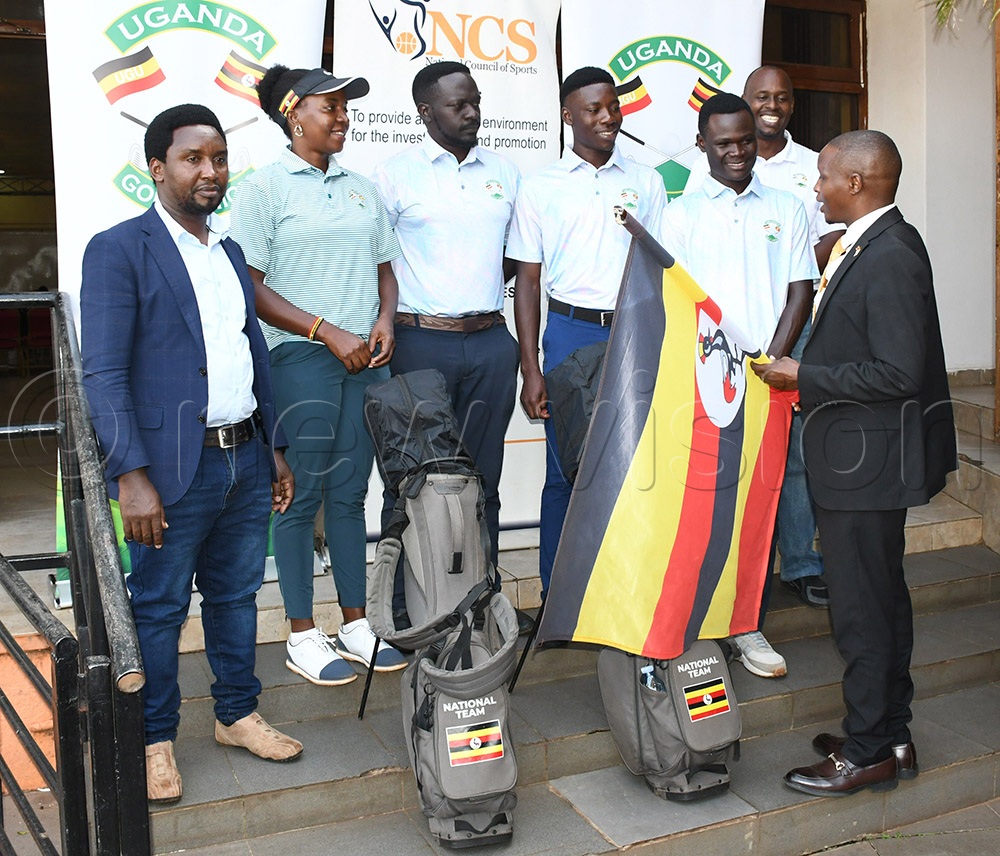 NCS's Milton Chebet (right) hands over the Ugandan flag to captain Joseph Akena (2nd right) alongside NCS Sports Officer Charles Cherop (left), coach Flavia Namakula, Joseph Kasozi, Godfrey Kambale, and team manager Paul Habyarimana (2nd right) before they left for the Africa Region IV Golf Championship in Madagascar, November 21, 2025. (Credit: Michael Nsubuga)