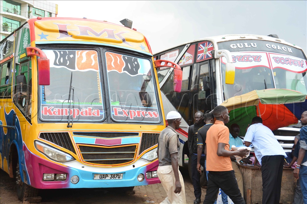 A bus ticket manager issues tickets to passengers to board Gulu Coach at Namayiba bus park in Kampala on Friday 12, 2025.