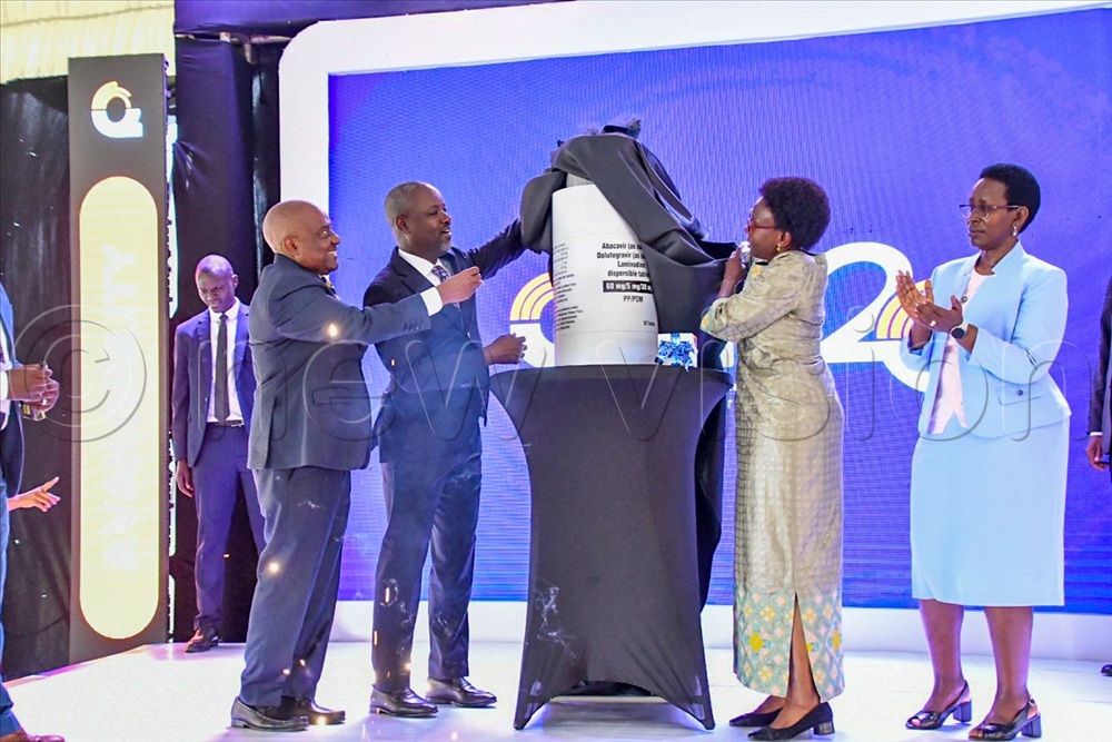 Deputy Speaker Thomas Tayebwa, Health miniter Jane Aceng unveil dummy packaging for a new drug as Chairman Quality Chemicals Emmanuel Katongole and PS Health Diana Atwine celebrate.