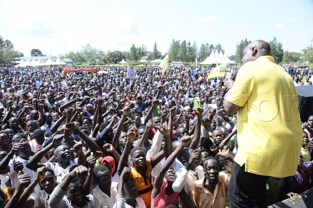 Hon. Dr Balaam Barugahara Ateenyi, Minister of State for Youth and Children Affairs charging up the crowd as they await President Museveni to arrive for the rally.(Credit: Eddie Ssejjoba)