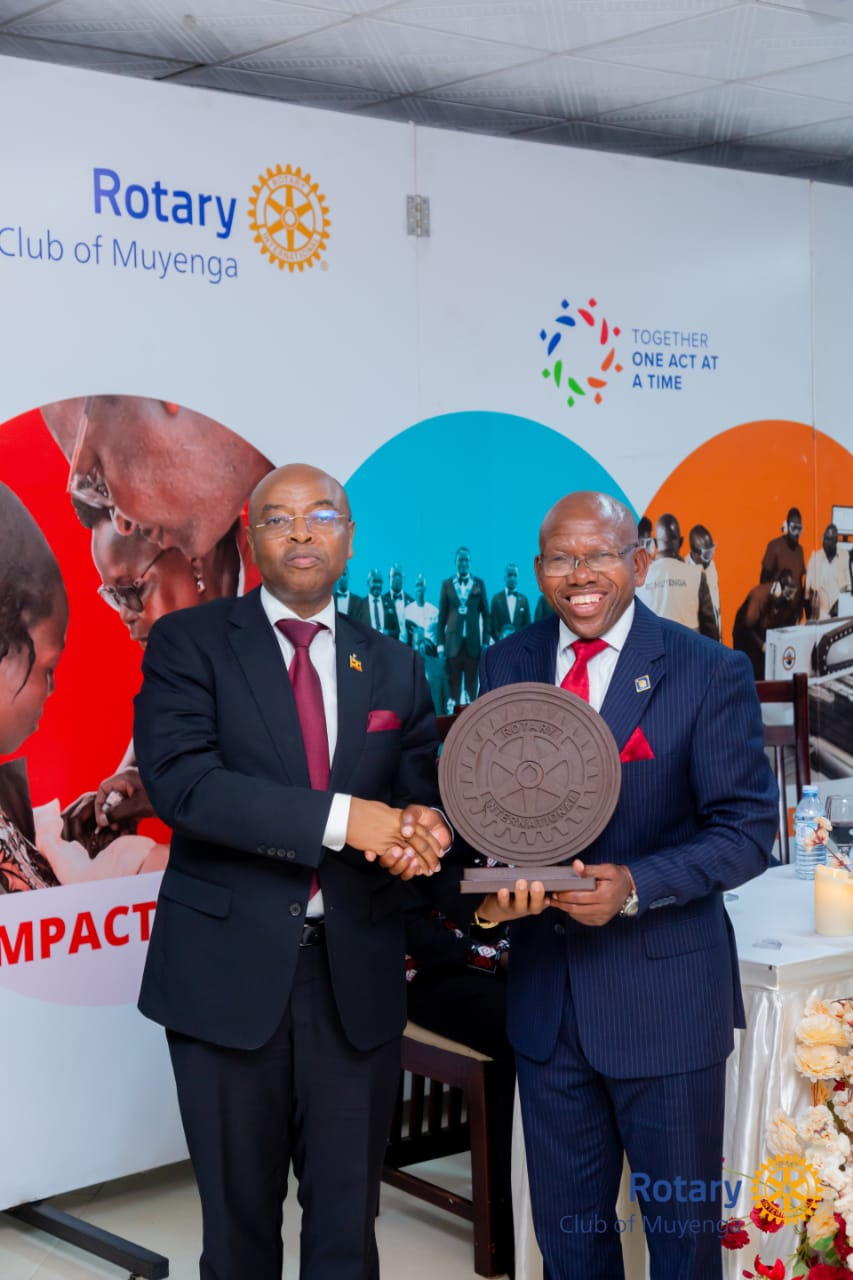 Deputy Governor Bank of Uganda Prof Augustus Nuwagaba poses for a photo with Rotarian Edison Besigomwe. (Courtesy photo)