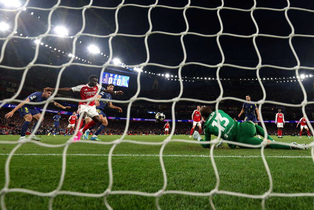 Arsenal's English midfielder #07 Bukayo Saka scores the team's first goal during the UEFA Champions League second-leg semi-final football match between Arsenal and Atletico Madrid at the Emirates Stadium in north London on May 5, 2026. (AFP)