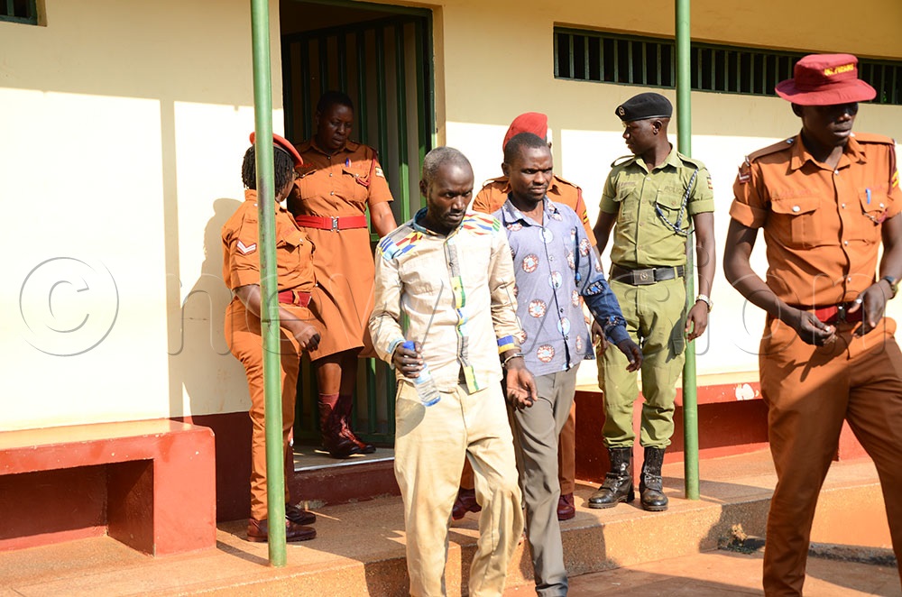Joshua Namurenge (L) and his colleague Martin Kipsanga at Masindi court in 2024. (New Vision Files/Yosam Gucwaki)