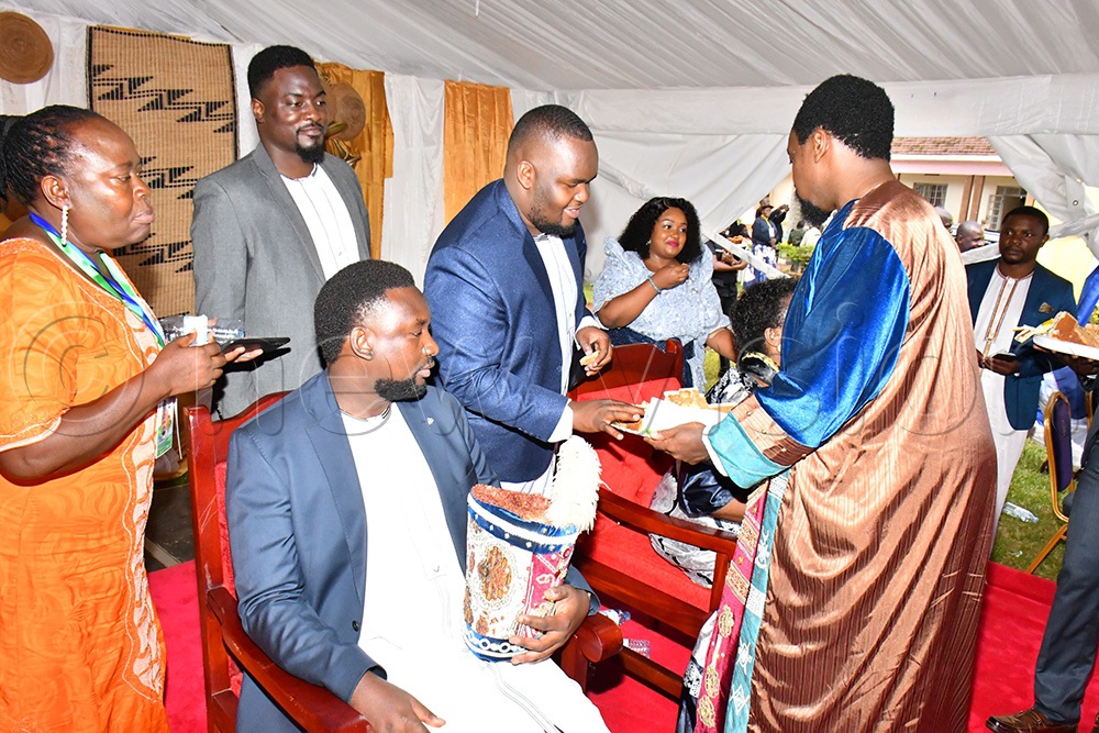 Kyabazinga William Gabula Nadiope IV (right) serving cake to members of his Royal Family while at his 11th Coronation Anniversary event at Busoga Kingdom headquarter ground on Saturday in Jinja City. (Photo by Donald Kiirya)