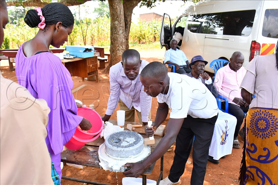 Residents of Busana Model viilage in Kamuli demonstrating how to use one of the Soya Milk processing equipment. (Credit: Donald Kiirya)