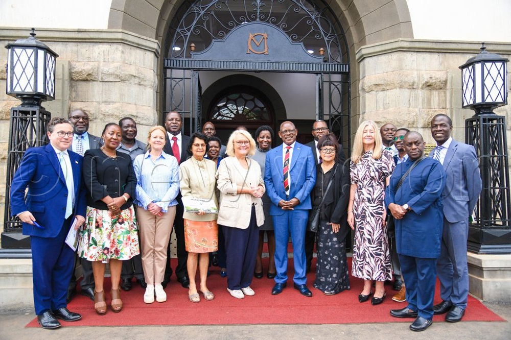 Guests from the University of West England in a group photo with Makerere University top administrators after signing the MoU on Friday.