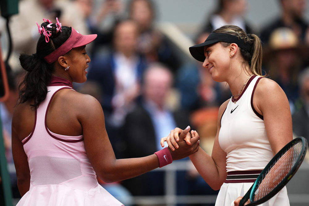Winner Spain's Paula Badosa (R) shakes hands with Japan's Naomi Osaka at the end of their women's singles match on day 2 of the French Open tennis tournament on Court Philippe-Chatrier at the Roland-Garros Complex in Paris on May 26, 2025. (Photo by Dimitar DILKOFF / AFP)