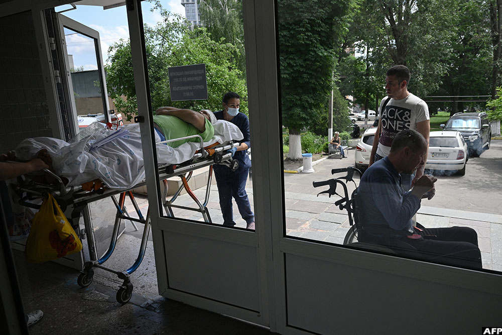 Hospital staff transport a patient in between departments of the Mechnikov Hospital in the city of Dnipro on June 8, 2026