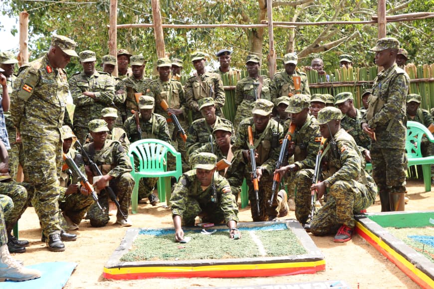 Brig Gen Michael Nyarwa, Commander Marine Brigade looks on as students demonstrate on a terrain model. 