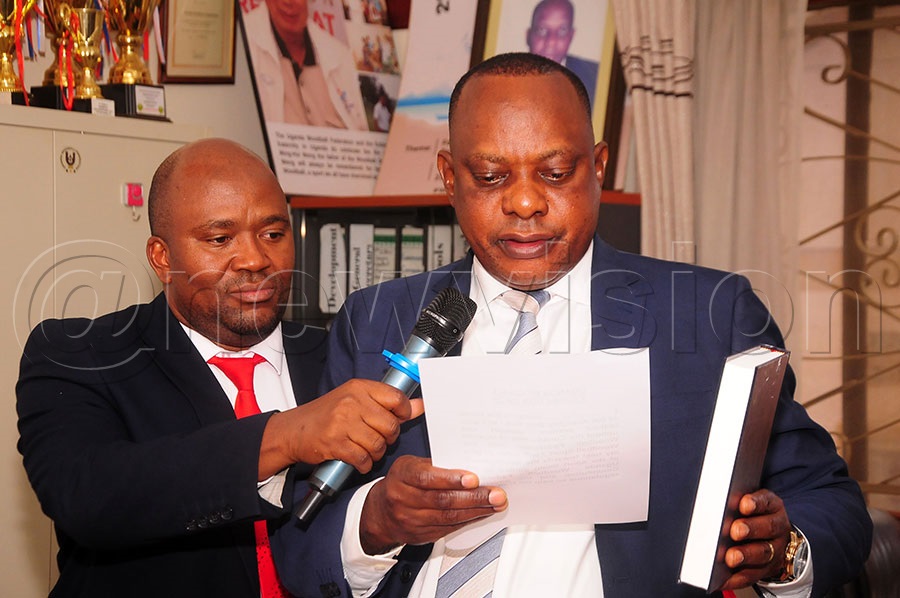 Kayongo (right) swearing in. Photo by Gerald Kikulwe