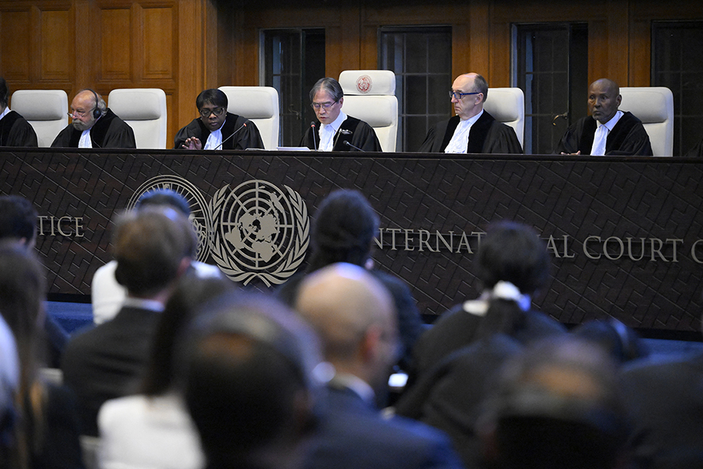 President of the International Court of Justice (ICJ) Yuji Iwasawa (C) and members issue first Advisory Opinion (AO) on States' legal obligations to address climate change, in The Hague on July 23, 2025. (AFP)