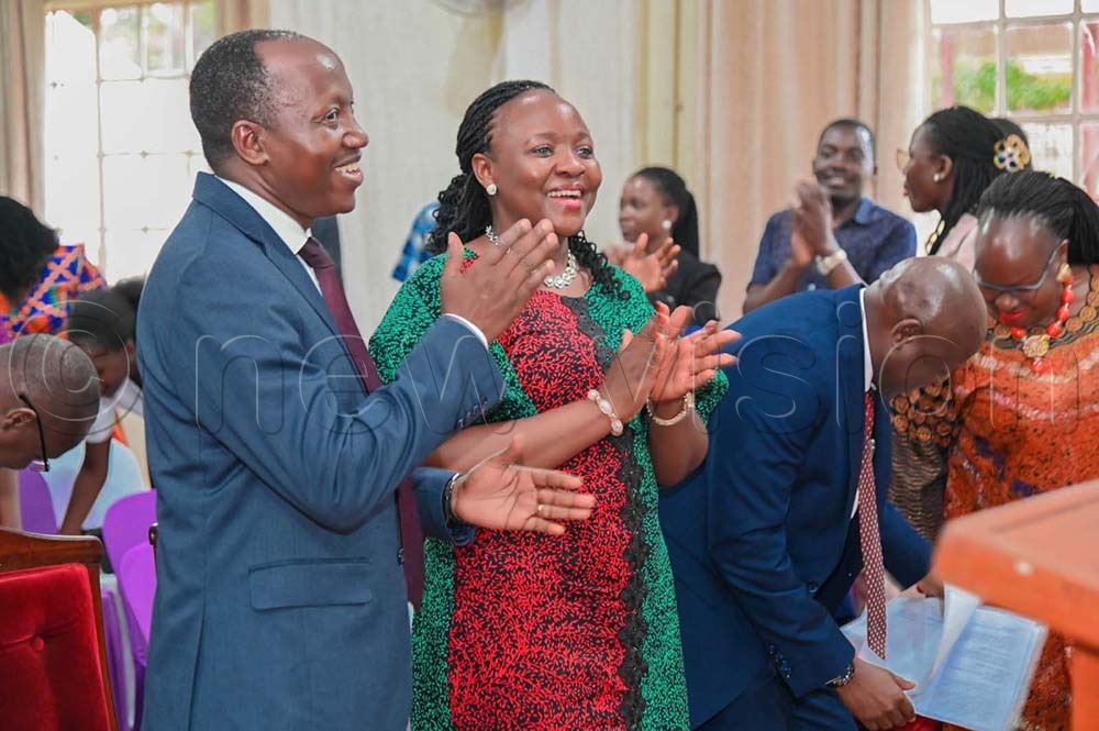 Dr Godfrey Siu, Fellowship Chairman, and Lady Justice Sarah Langa Siu, Chairperson Mothers’ Union, clapping hands during the service. (Credit: Violet Nabatanzi)