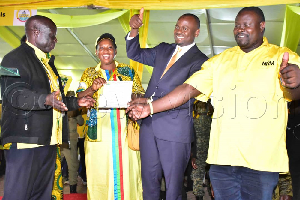 Haruna Kasolo, the microfinance and small enterprises state minister, receiving his results from the NRM electoral commission chairperson after being declared vice-chairperson, central region winner. (Photo by Joseph Mutebi)