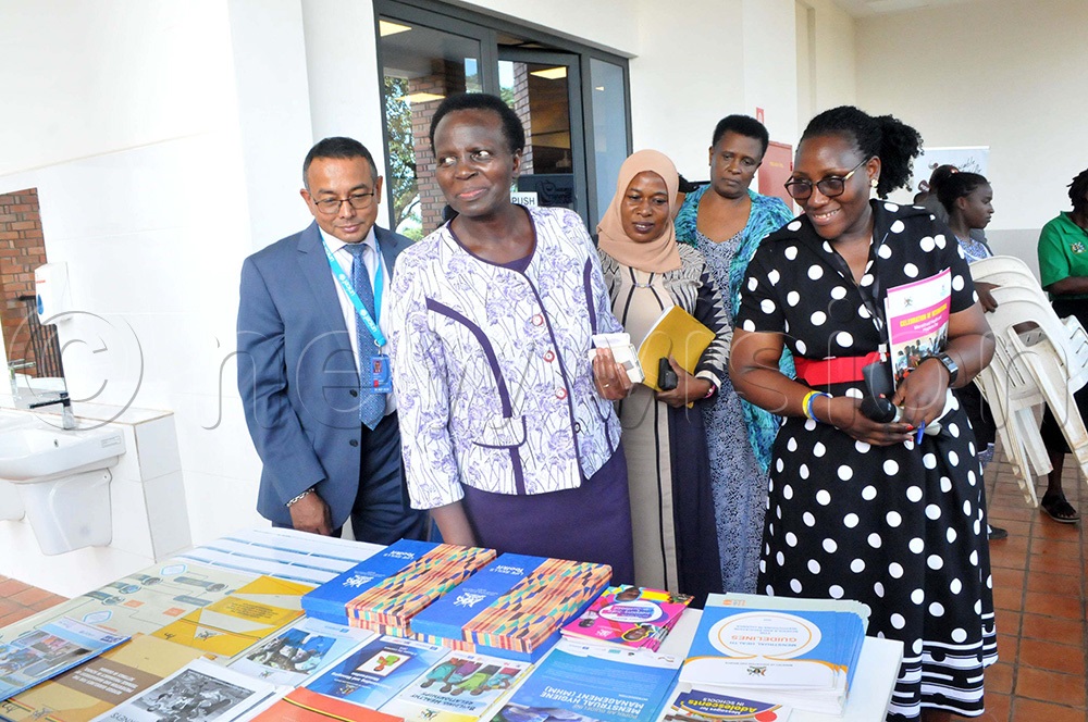 (L-R) Robin Nandy, the UNICEF Representative with Kedrace Turyagyenda, the Permanent Secretary Ministry of Education and Sports, Safina mutumba, the Principal Education Officer Ministry of Education and Angela Nansubuga, the Gender Mainstreaming Unit at the Ministry of Education touring stalls. (Photo by Nicholas Oneal)