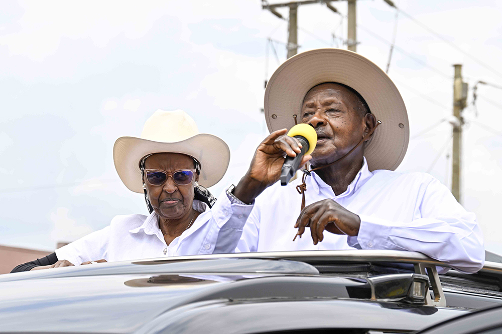 President Yoweri Museveni speaking as the First Lady looks on.