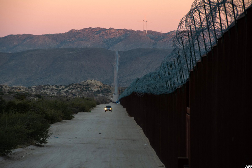Migrants huddle in openair camps on US border New Vision Official