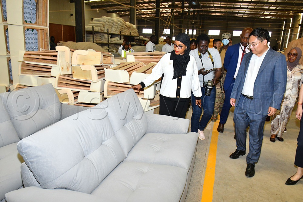 The State Minister for Privatisation and Investment, Hajjati Aminah Mukalazi (left), admiring a sofa set made at Tian’ao Furniture Manufacturing Co. Ltd during her tour at Sino-Uganda Mbale Industrial Park on August 26th. (Photo by Donald Kiirya)