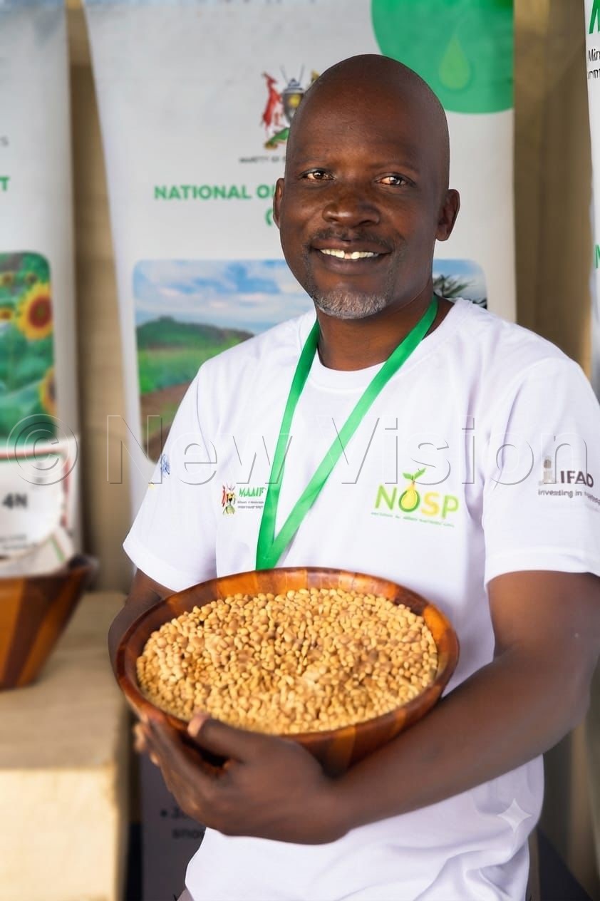 Moshebo showcases his soybeans during the National Agriculture Show. (Credit: Prossy Nandudu)