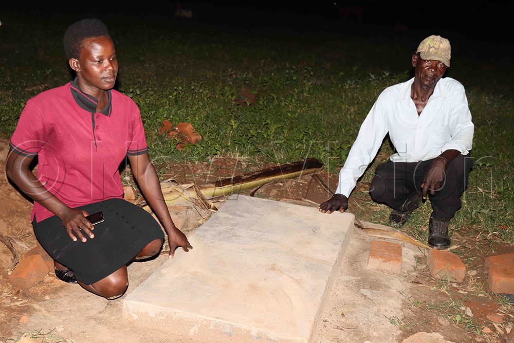 Obura and her father pay respect to her son. (Credit: Hudson Apunyo)
