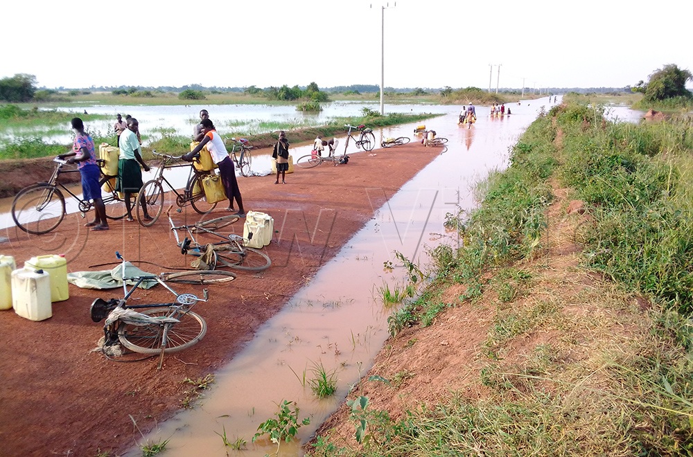 Sometimes a curse can turn into a blessing: Flooded roads become water sources for residents of Amolatar.