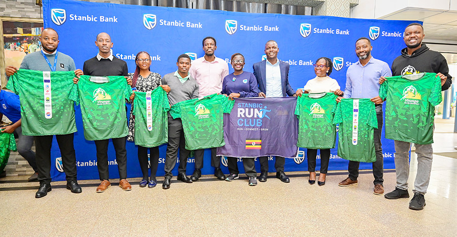 Stanbic Bank Run Club members and other officials display the Virunga Gorilla Marathon 2026 Kit. Courtesy photo