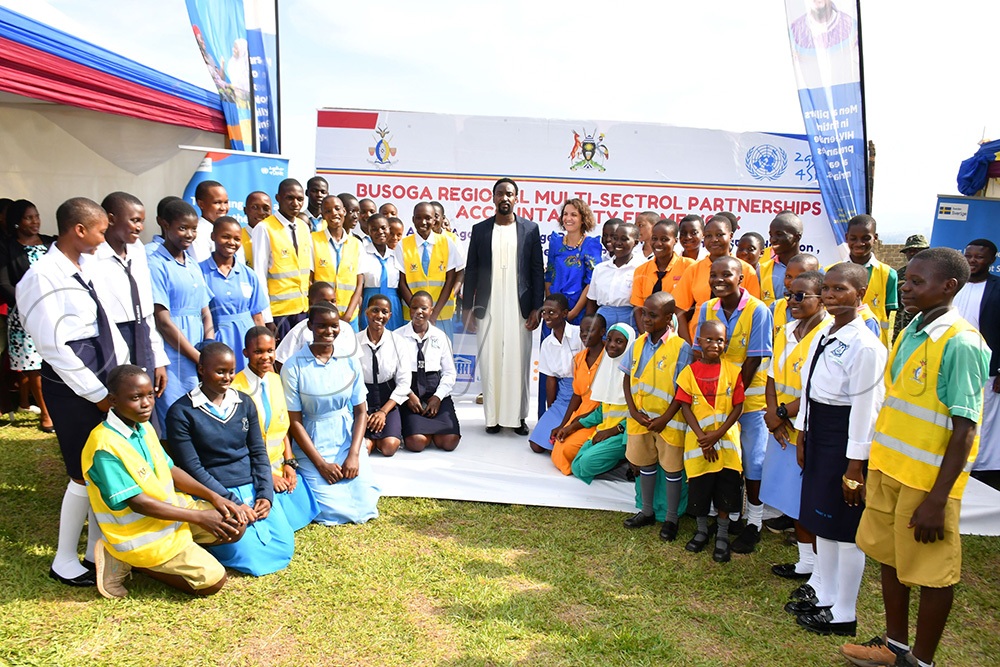 Kyabazinga of Busoga William Gabula Nadiope IV (middle) and Laura Lafuente Criado (in blue Gomesi) pose for a photo moment with students and pupils from various schools after launching the Busoga Regional Multi-Sectoral Partnerships and Accountability Framework 2026-2030 at Igenge Palace in Jinja City on October 22nd. (Photo by Donald Kiirya)