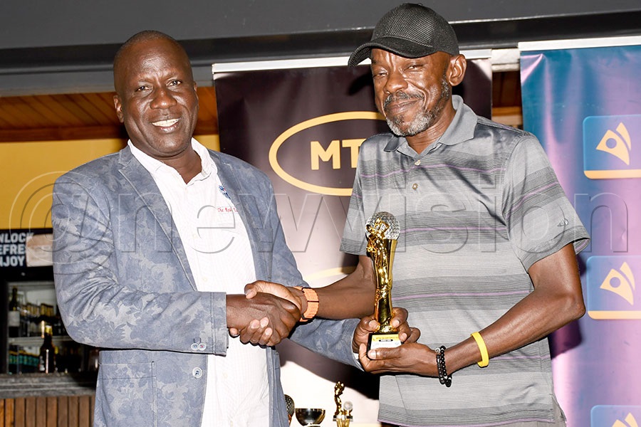 Men's Group A winner Charles Odere (left) receives her trophy from MTN's Michael Sekadde after the MTN Monthly Tees tournament for the month of march at Entebbe Club, March 21, 2026. Photo by Michael Nsubuga