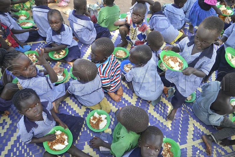 Pupils of Alaba primary school for meals during lunch. (Photo By Robert Ariaka)