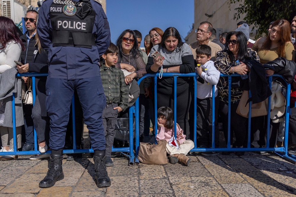 Tourists, palestinians and pilgrims gather in Manger Square, ahead of the arrival of Latin Patriarch of Jerusalem to celebrate Christmas Mass, in the biblical city of Bethlehem in the Israeli-occupied West Bank on Christmas eve on December 24, 2025. (AFP)
