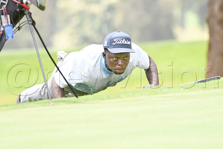 Dominic Musonda reads his line on hole 12  during  the second round. Photo by Michael Nsubuga