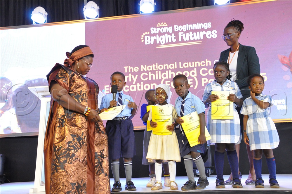 Pupils handing over Early Childhood Care and Education policy report 2025 to Joyce Kaducu, the Minister of State for Primary Education. This was during the launch of the Early Childhood Care and Education policy at Nakivubo Blue Primary School on April 30, 2026. 