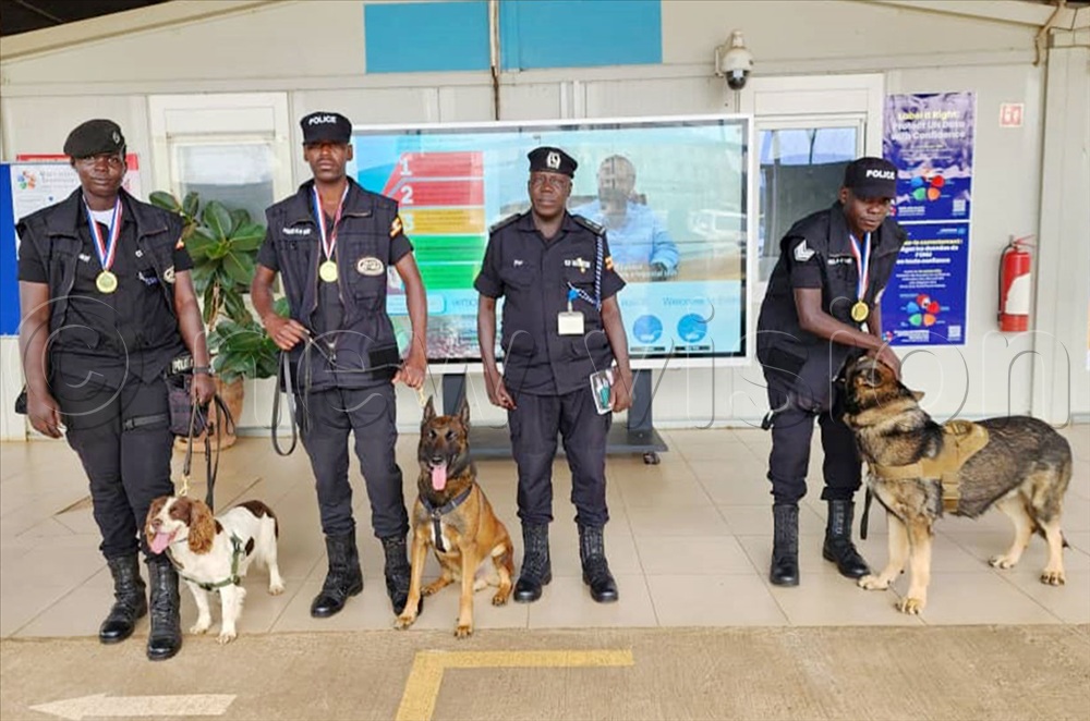 The dogs which were decorated with medals pose for photo with their handlers at the United National Regional Service Center, Entebbe.