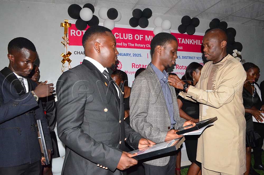 Past District Governor Ken Mugisha District 9214 pinning members of Rotaract Club of Muyenga Tank Hill at  Hotel International Muyenga. (Credit: Violet Nabatanzi)