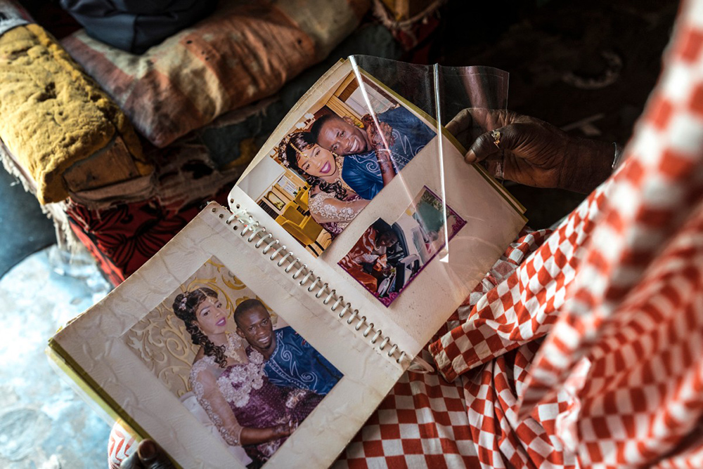 Fatou Ngom shows a photo of herself with her husband Assan Gueye at her home in Mbour, on March 9, 2026. Fatou was left to raise her three children by herself after her husband died in 2022 trying to reach Europe through the Atlantic route. (Photo by PATRICK MEINHARDT / AFP)
