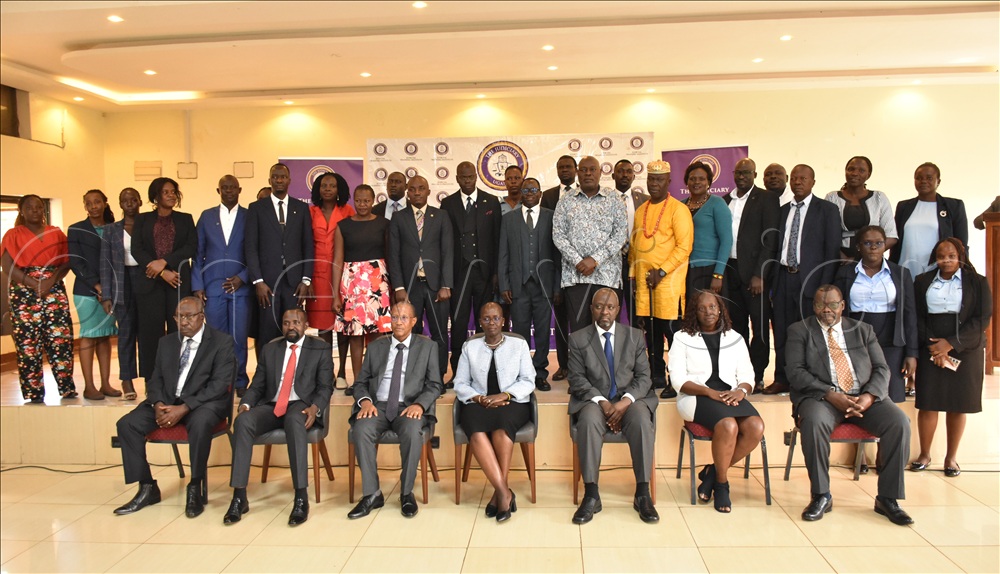 The Principal Judge, Jane Frances Abodo and others pose for a group photo with other stakeholders.
